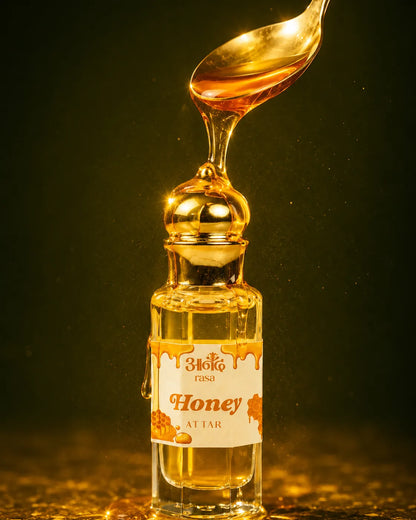 Bijaka Rasa Honey Attar is displayed in a glass bottle with a gold cap, featuring a dramatic honey-pouring presentation. - handcrafted attar - Anandrasa