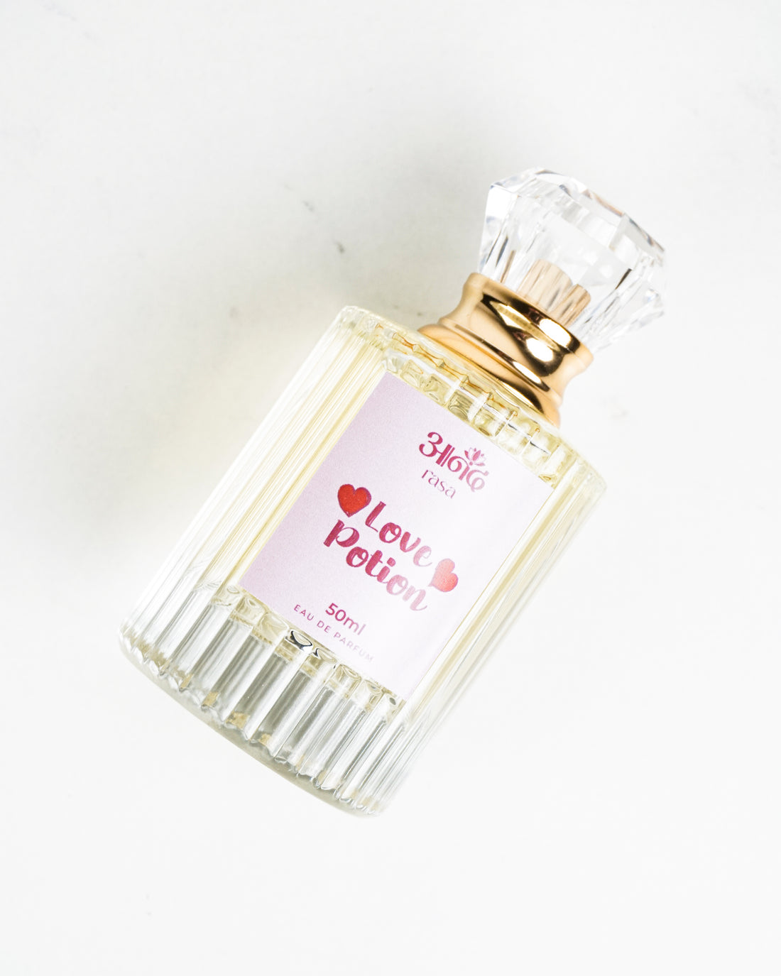 3180 Love Potion 50ml perfume bottle with pink label, gold collar and clear faceted cap