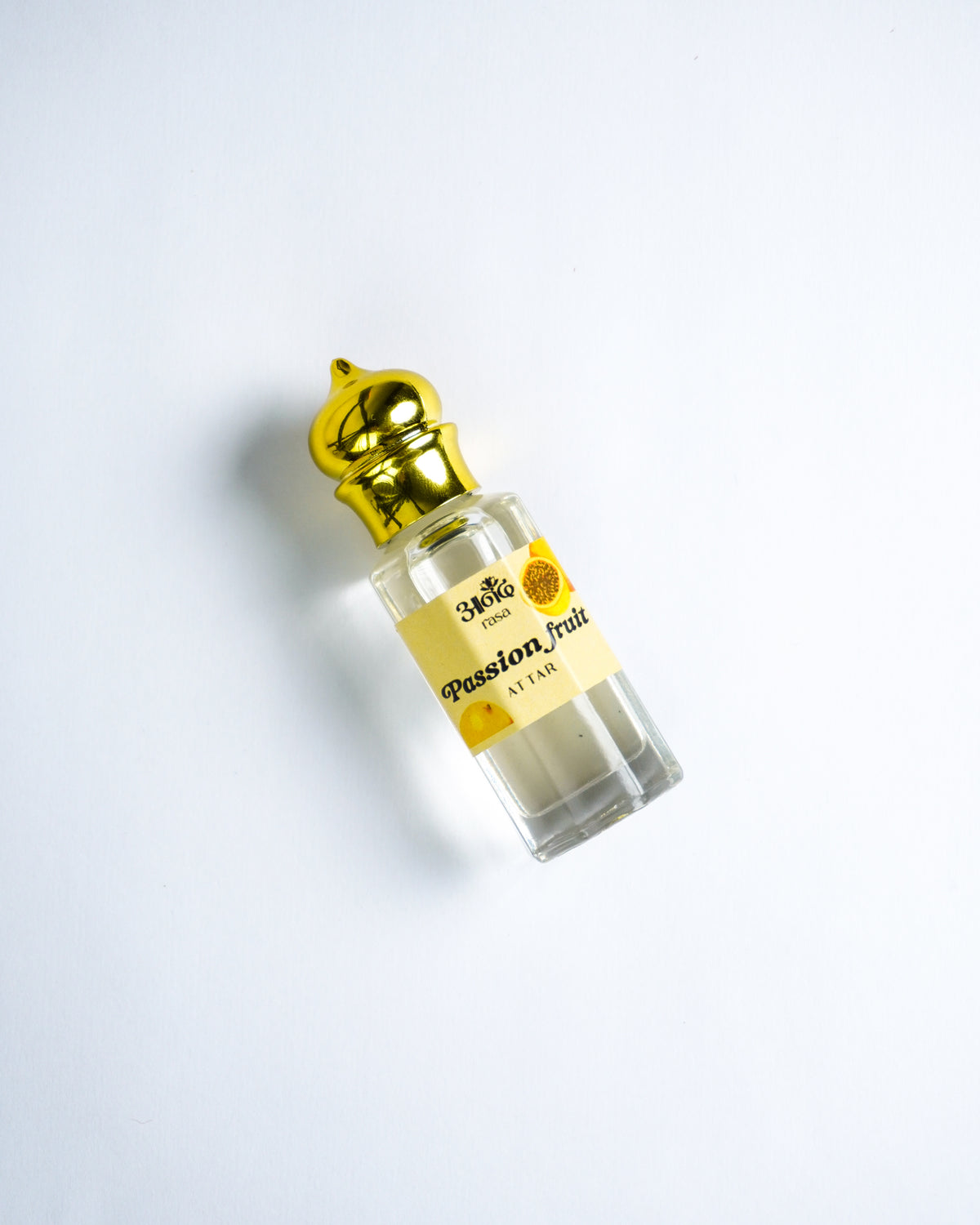 Passion Fruit Attar perfume bottle with golden cap on a clean white background.