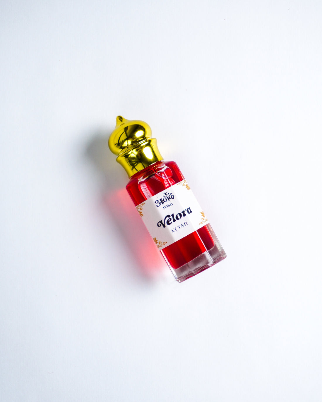 Violet perfume attar in a glass bottle with a natural Rasa jute pouch