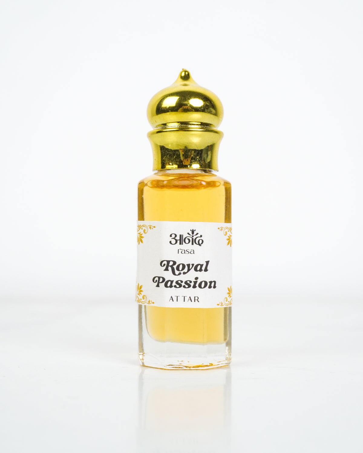 Anand Rosa Royal Passion Attar perfume oil in a clear glass bottle with a gold cap on a white background